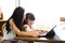 Mother And Teenage Daughter Looking At Laptop Together