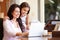 Mother And Teenage Daughter Looking At Laptop Together