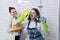 Mother and teenager daughter cleaning together in bathroom