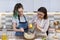 Mother and teenager daughter cook together at home in kitchen