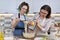 Mother and teenager daughter cook together at home in kitchen