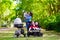 Mother with three children in buggy and stroller