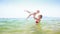 Mother Tosses High up Little Daughter in Azure Sea