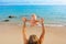 Mother tossing to mid air happy baby on sea beach