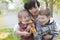 Mother and two children admiring spring garden