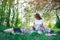 Mother and two children on picnic in Park. Carefree motherhood childhood