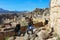 Mother and two children at ruins of ancient Mycenae Greece with snowcapped mountians in the background 1 5 2018