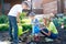 Mother with two children sons planting a tree and watering it together in garden