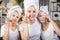 Mother with two daughters cleaning face with cotton pads