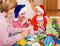 Mother with two daughters doing applique work