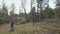 Mother with two daughters walking by the forest