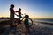 Mother with two kids biking at sunset