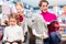 Mother with two kids shopping in toy store