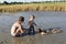 Mother and two sons in healing mud