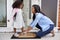 Mother Tying Daughters Shoelaces As She Leaves For School