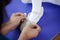 Mother tying feet pointe shoes to her daughter