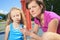 Mother using inhaler with her asthmatic daughter