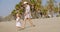 Mother walking on a beach with her small daughter