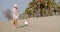 Mother walking on a beach with her small daughter