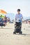 Mother walking on beach and push baby carriage