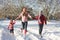 Mother Walking With Children Through Snow