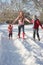 Mother Walking With Children Through Snowy Landsca