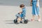 mother walking with her child son on a cute bicycle