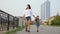 Mother walks with Korean little girl along embankment