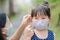 Mother is wearing a cloth mask for little girl protect herself from Coronavirus when child leave the house mom is wearing mask on