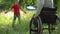 Mother in a wheel chair playing frisbee with son outdoors.