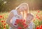 Mother in white with daughter together on blossoming red poppies field