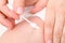 Mother wipes newborn baby navel with cotton swab