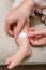 Mother woman sticks a medical adhesive plaster on the toddler baby l