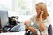 Mother working in home office with baby