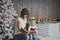 Mother year-old daughter read the book in Christmas decorations