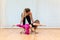 mother, yoga and pilates instructor, and daughter, Caucasian, do plank exercises