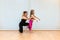 mother, yoga and pilates instructor, and daughter, do balance exercises