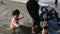 Mother and young child playing with sand at beach