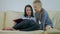 Mother and young daughter reading book on couch at home. Time only for mother and her little daughter.