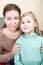 Mother with young girl sitting together indoor