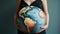 Motherhood Blooms: Embracing Life with a Globe-Inspired Pregnancy Glow