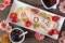 Mothers Day breakfast heart shaped pancakes with MOM letters, above view table scene on rustic wood