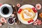 Mothers Day breakfast pancakes with heart shape and MOM letters, overhead view table scene on rustic wood