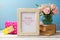 Mothers day greeting card with rose flower bouquet, gift box and photo frame