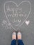 Mothers day - heart shape chalk drawing and the feet of a mother