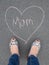 Mothers day - heart shape chalk drawing and the feet of a mother