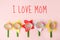 Mothers day message I LOVE MOM with handicraft flowers on pastel pink board, creative idea, holiday card, kidergarten day care diy