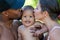 Mothers and father kissed Biracial baby. kissing baby. Mother kiss child, father caring baby. Closeup face of