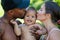 Mothers and father kissed Biracial baby. kissing baby. Mother kiss child, father caring baby. Closeup face of