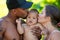 Mothers and father kissed Biracial baby. kissing baby. Mother kiss child, father caring baby. Closeup face of